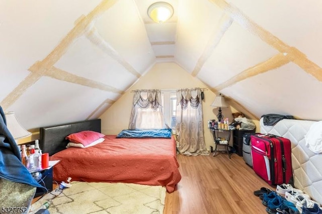 bedroom featuring vaulted ceiling and hardwood / wood-style flooring