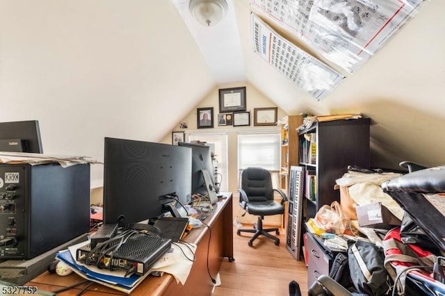 home office featuring vaulted ceiling and light wood-type flooring