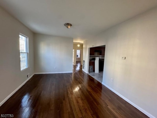 unfurnished living room featuring dark hardwood / wood-style floors