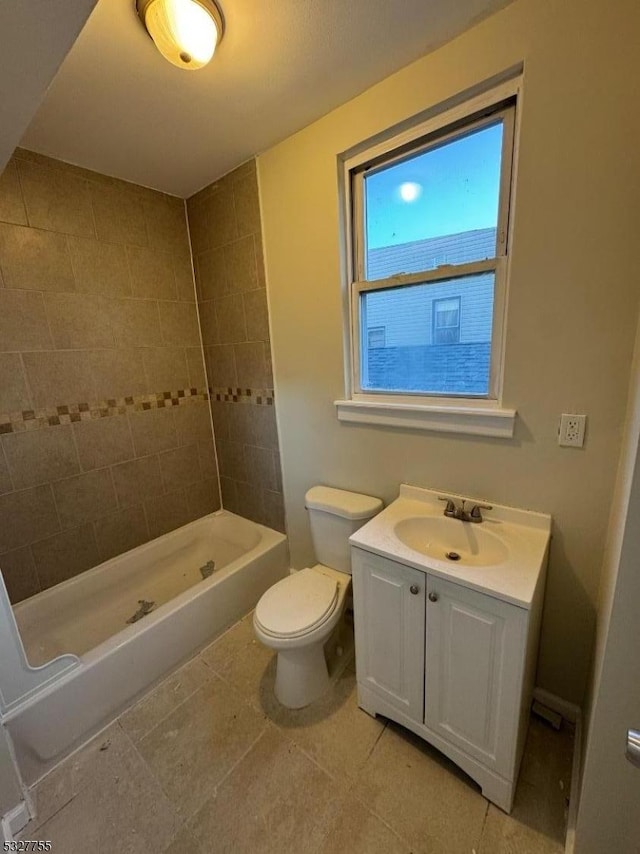 bathroom with vanity, toilet, and tiled shower