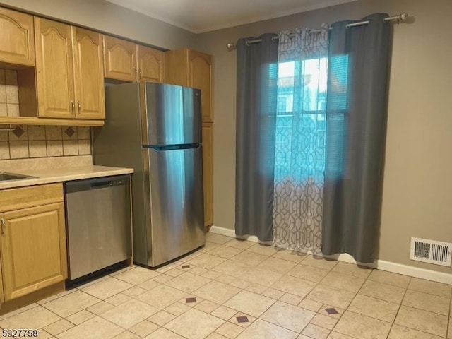 kitchen with light brown cabinets, stainless steel appliances, crown molding, decorative backsplash, and light tile patterned floors