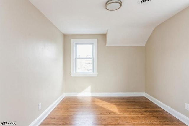 bonus room featuring hardwood / wood-style floors and vaulted ceiling