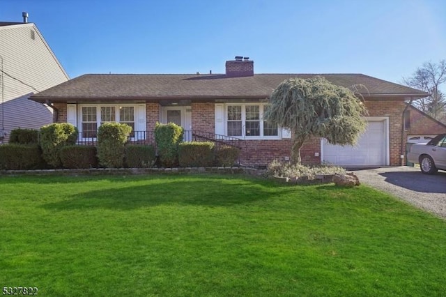 ranch-style house with a garage and a front lawn