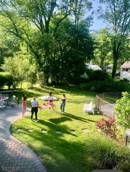 view of property's community with a patio area and a lawn