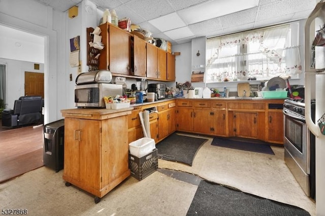 kitchen with a drop ceiling and stainless steel appliances