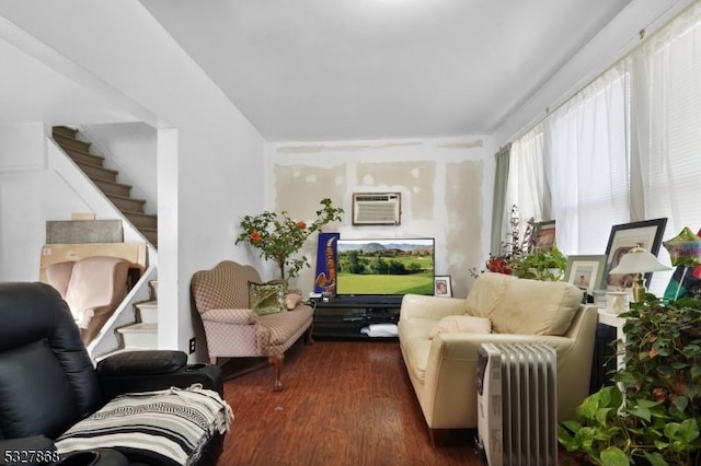 living room featuring radiator heating unit, dark hardwood / wood-style flooring, and an AC wall unit