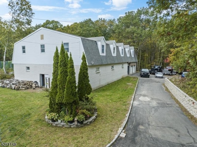 view of property exterior with a lawn