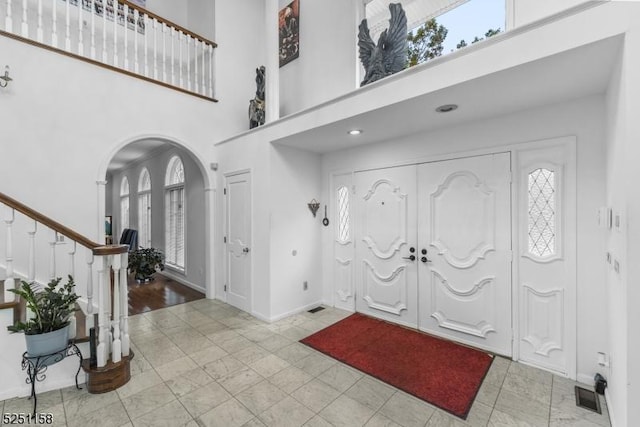 foyer featuring light hardwood / wood-style floors and a high ceiling