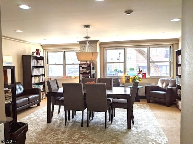 dining space featuring crown molding