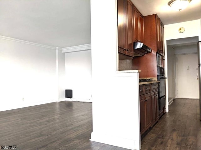 kitchen featuring dark hardwood / wood-style floors, crown molding, extractor fan, and black oven