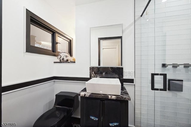 bathroom with vanity and a shower with door