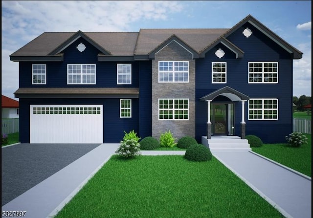 view of front of house featuring a garage and a front yard