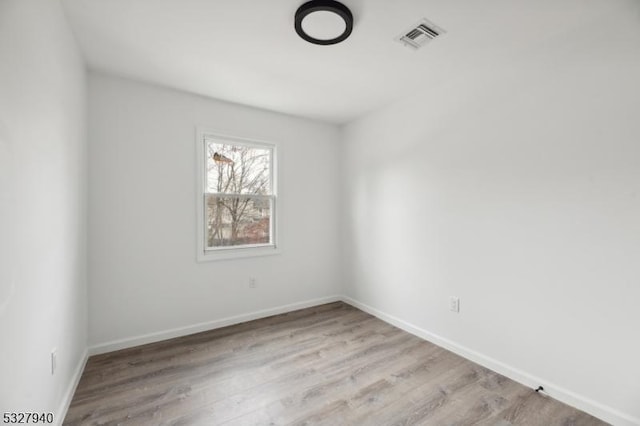 spare room with light hardwood / wood-style flooring