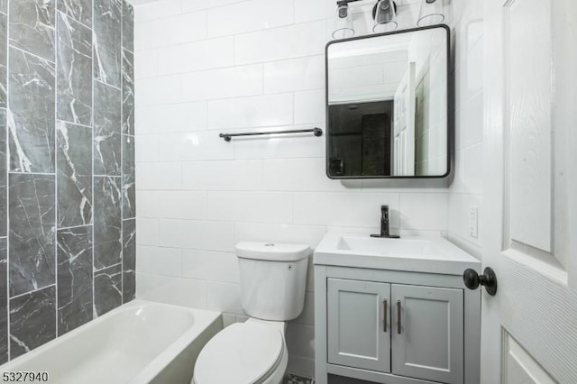 full bathroom featuring shower / bathtub combination, vanity, toilet, and tile walls