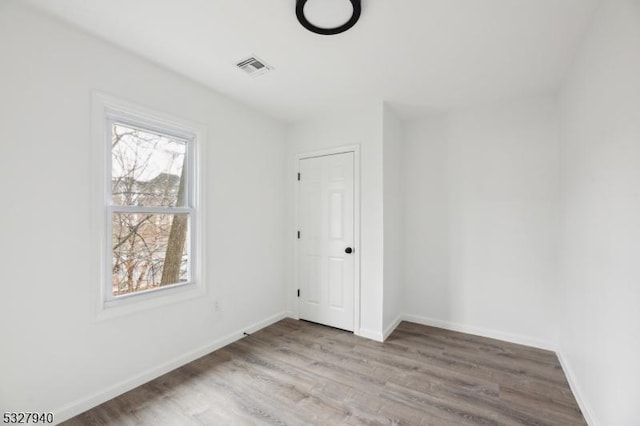 unfurnished room with light wood-type flooring