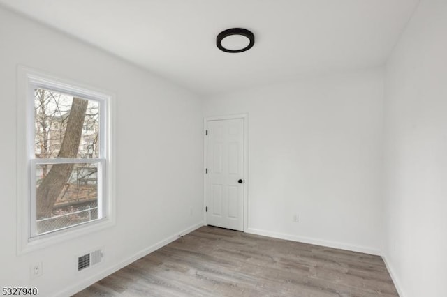 empty room with light hardwood / wood-style flooring