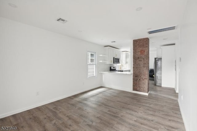 unfurnished living room featuring hardwood / wood-style floors