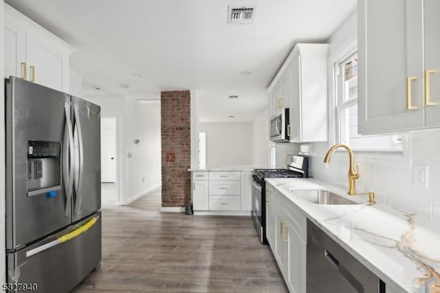 kitchen featuring dark hardwood / wood-style flooring, white cabinetry, sink, and appliances with stainless steel finishes