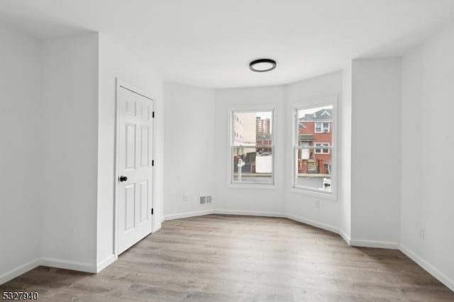 spare room with light wood-type flooring