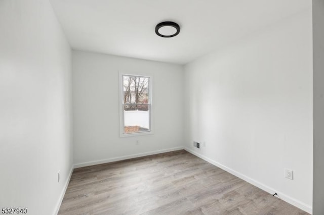 unfurnished room with light wood-type flooring