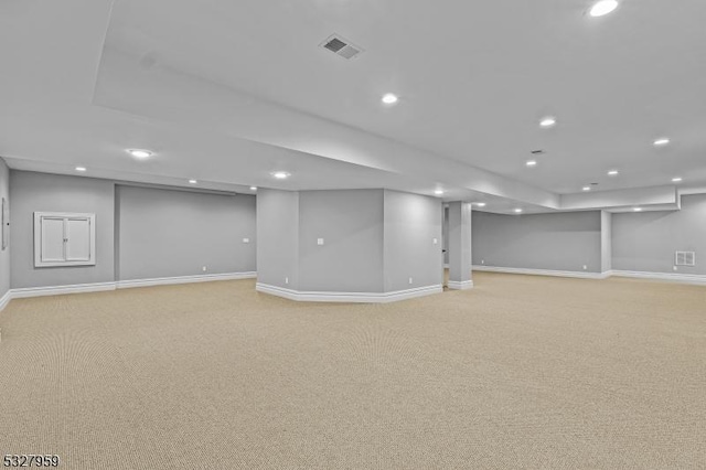 basement featuring light carpet