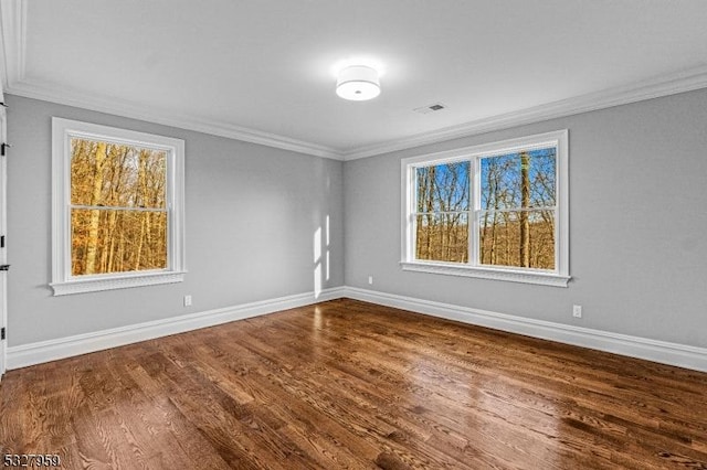 unfurnished room with hardwood / wood-style flooring and ornamental molding