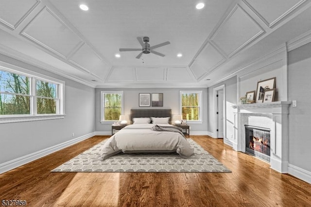 bedroom featuring hardwood / wood-style floors, ceiling fan, and ornamental molding