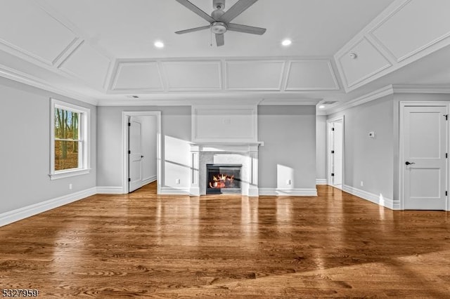 unfurnished living room with a fireplace, hardwood / wood-style floors, ceiling fan, and crown molding