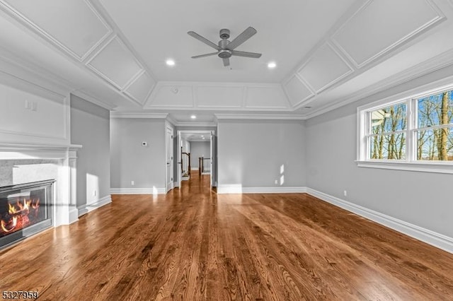 unfurnished living room with ceiling fan, wood-type flooring, and crown molding