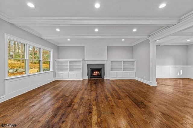 unfurnished living room featuring beam ceiling, hardwood / wood-style floors, and ornamental molding