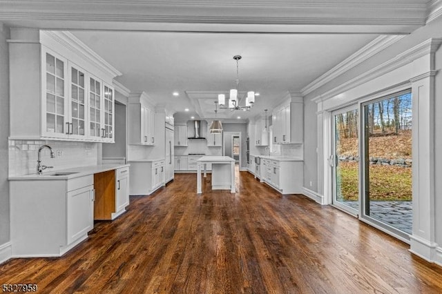 kitchen featuring white cabinets, a center island, and sink