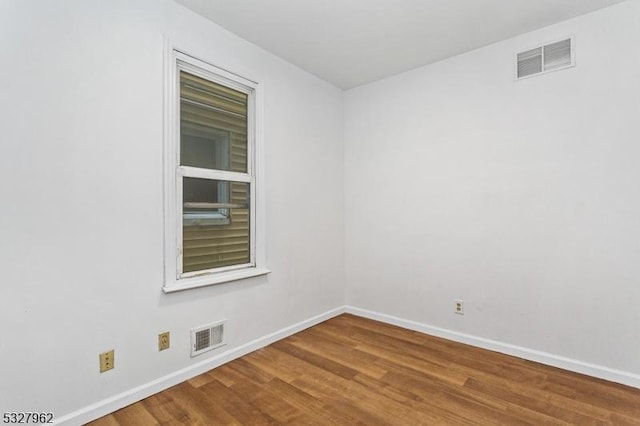 unfurnished room featuring wood-type flooring