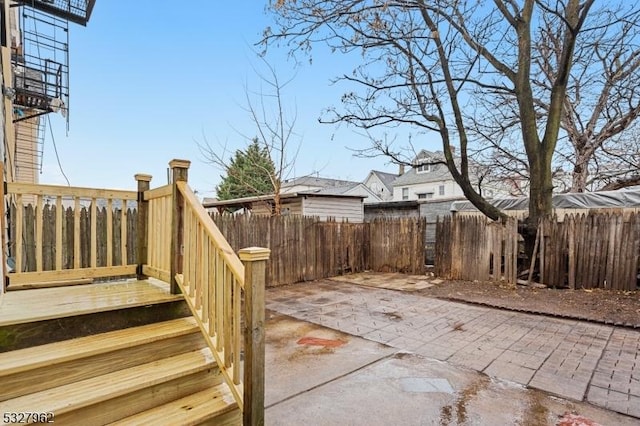 wooden terrace with a patio area