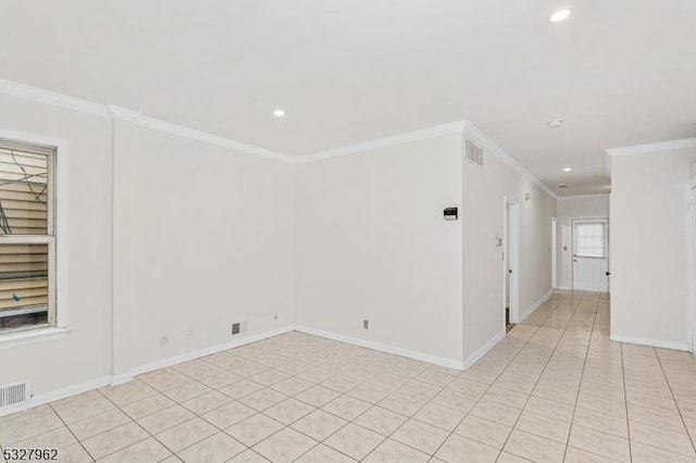 unfurnished room with light tile patterned floors and crown molding