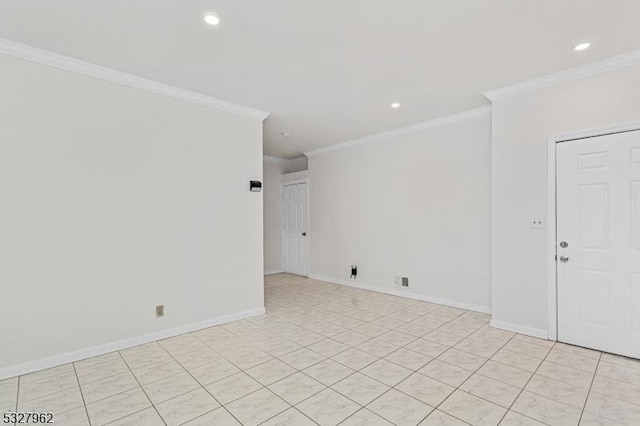 empty room featuring light tile patterned floors and crown molding