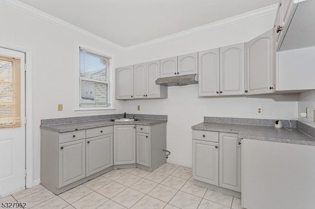 kitchen featuring gray cabinets, ornamental molding, sink, and light tile patterned floors