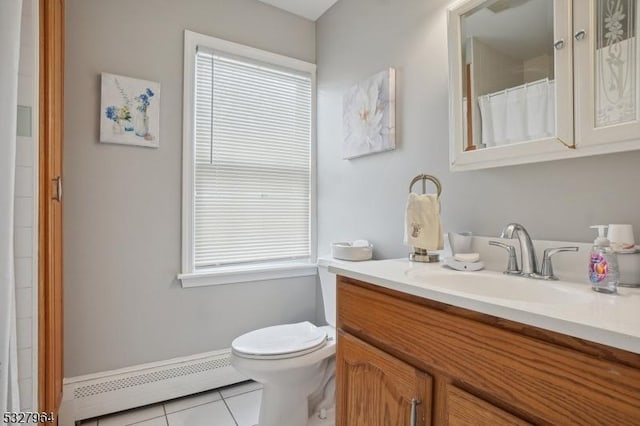 bathroom with tile patterned flooring, vanity, toilet, and a baseboard heating unit