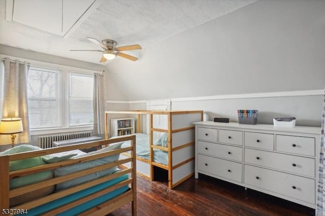 bedroom featuring lofted ceiling, radiator, ceiling fan, a textured ceiling, and dark hardwood / wood-style flooring