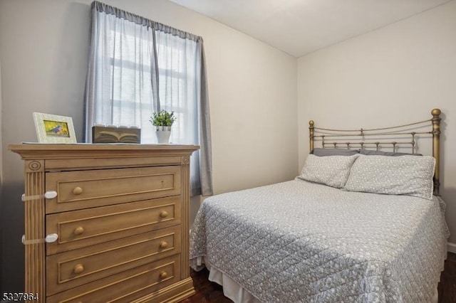 bedroom featuring dark hardwood / wood-style flooring