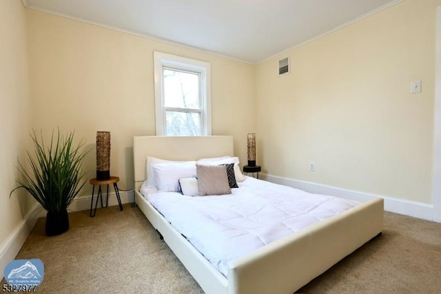 carpeted bedroom with ornamental molding