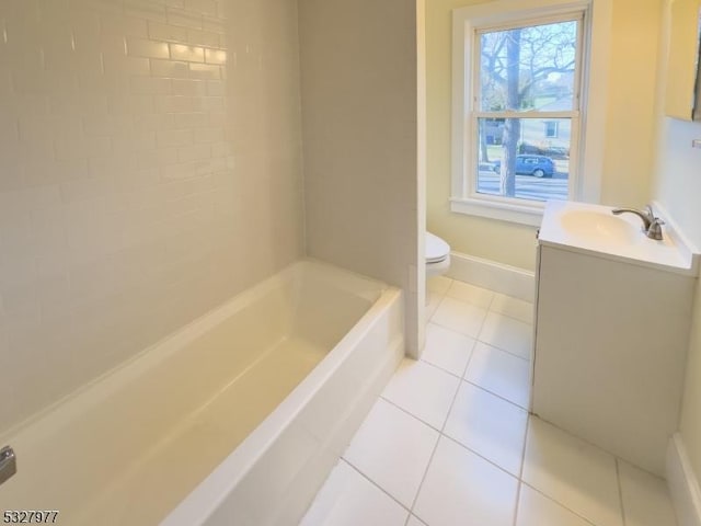 full bathroom with vanity, tiled shower / bath combo, tile patterned floors, and toilet