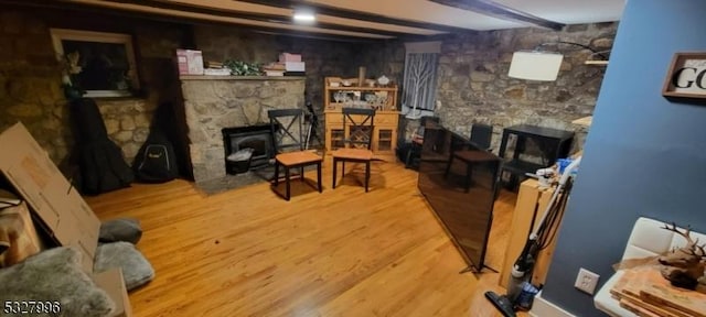 living room with light wood-type flooring and beam ceiling