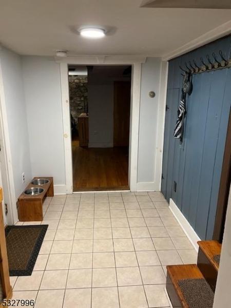 corridor featuring light tile patterned floors