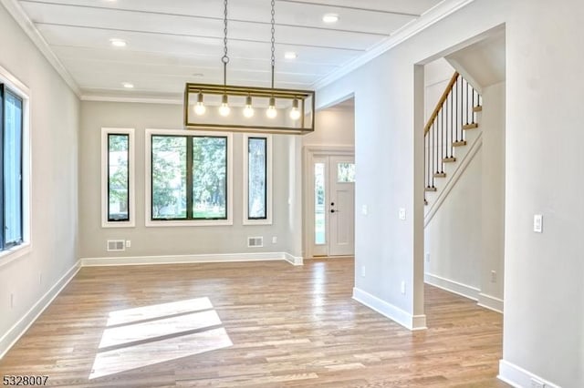 interior space with light wood-type flooring and ornamental molding