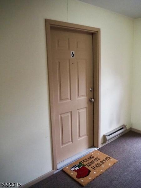 entrance to property featuring a baseboard radiator