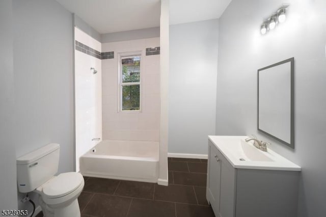 full bathroom featuring tile patterned flooring, vanity, tiled shower / bath combo, and toilet