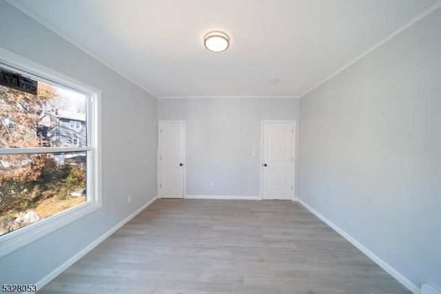 spare room with light hardwood / wood-style flooring and ornamental molding