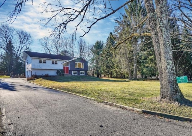 raised ranch featuring a front lawn