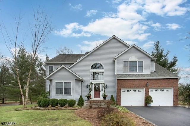 view of front property featuring a garage and a front yard