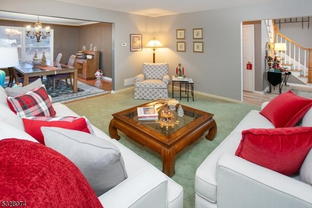 carpeted living room featuring a chandelier